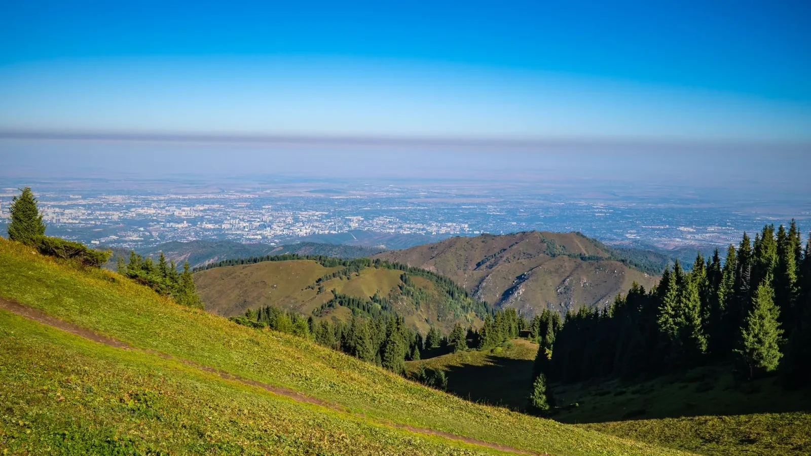 Almaty skyline and Tian Shan mountains, a main entry point for travellers from Kazakhstan visa-free countries