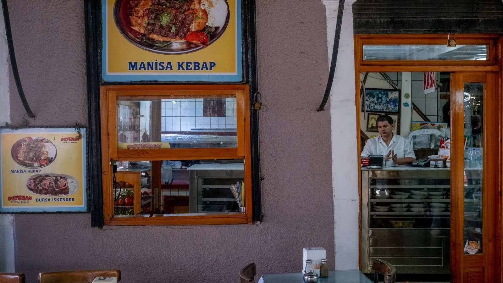 A waiter at the counter of a traditional Turkish restaurant