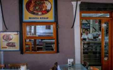 A waiter at the counter of a traditional Turkish restaurant