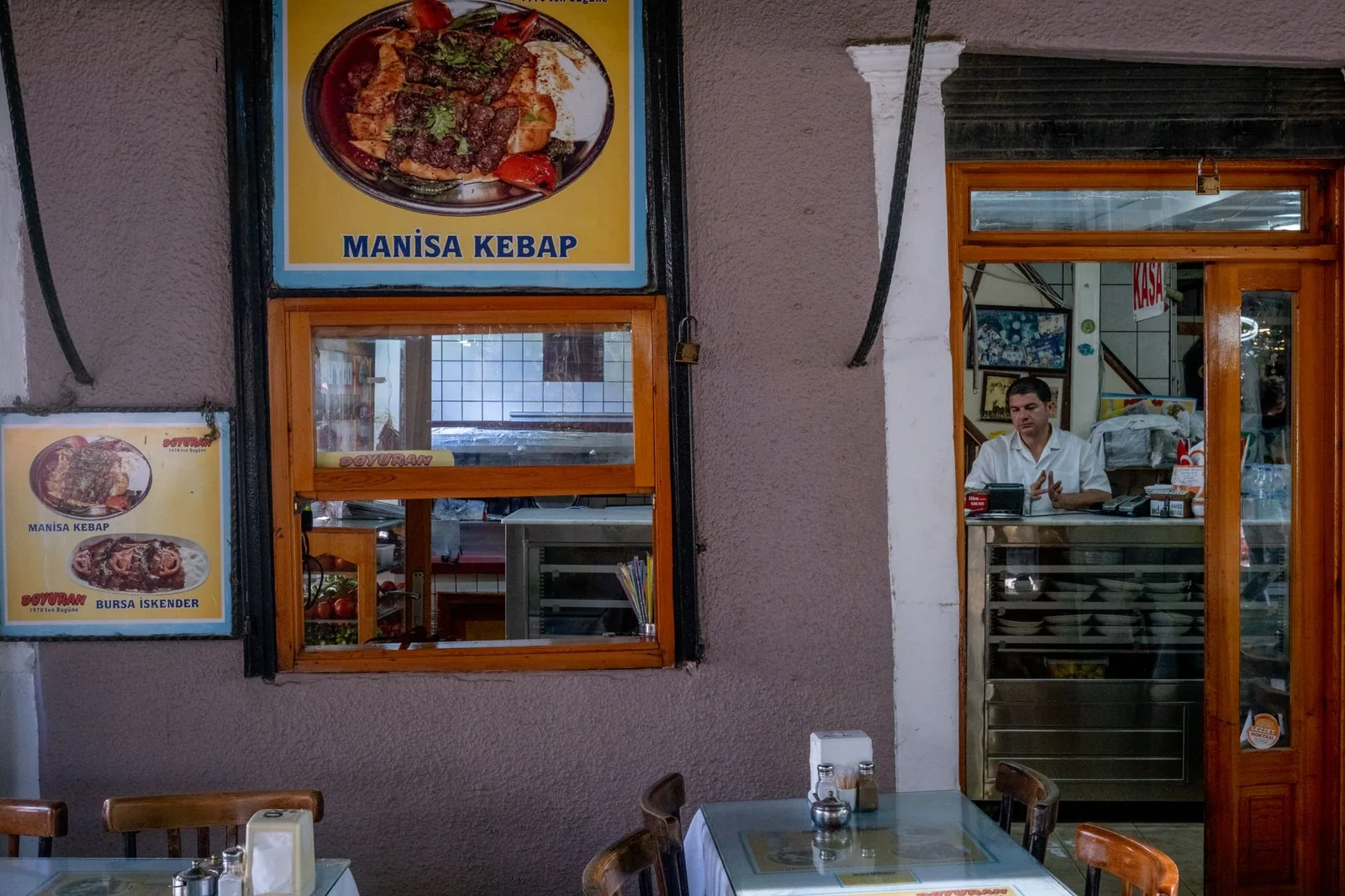 A waiter at the counter of a traditional Turkish restaurant