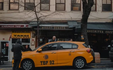 A yellow taxi parked outside shops in Istanbul's Kuzguncuk neighbourhood