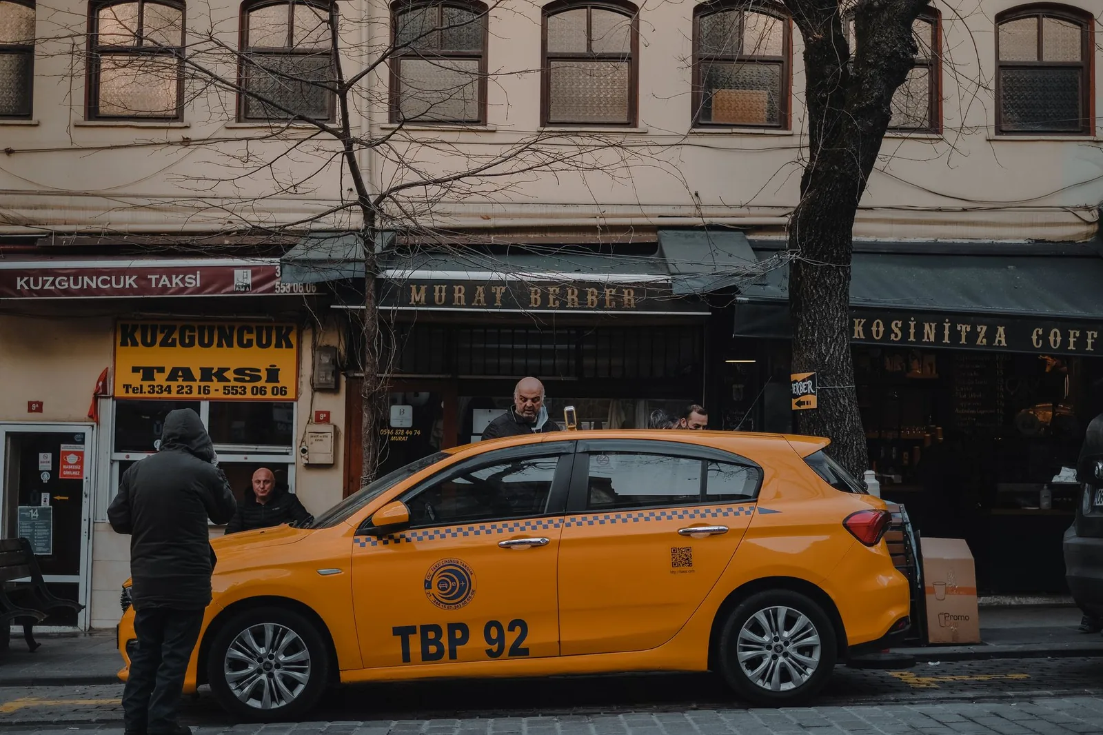 A yellow taxi parked outside shops in Istanbul's Kuzguncuk neighbourhood